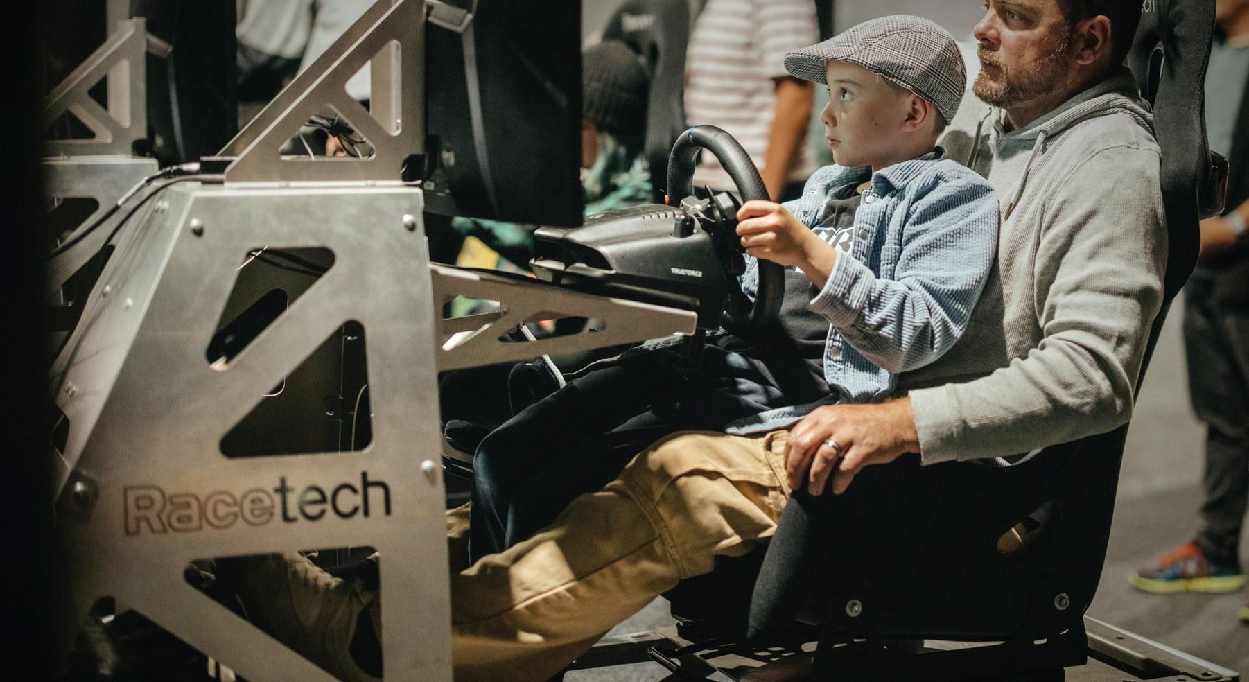 Father and son racing on a Ping Zero sim rig